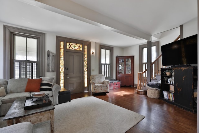 living room featuring plenty of natural light, wood finished floors, and stairway