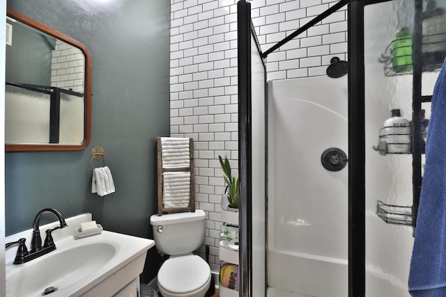 bathroom with vanity, a stall shower, and toilet