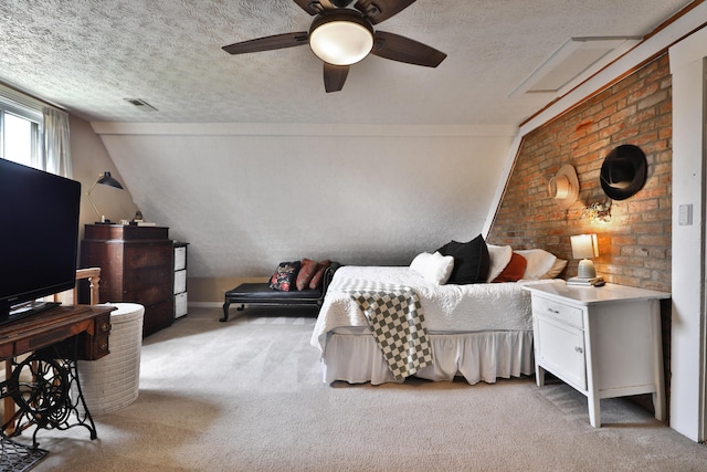 bedroom with light carpet, vaulted ceiling, a textured ceiling, and visible vents