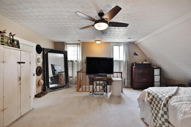 carpeted bedroom featuring a textured ceiling and multiple windows