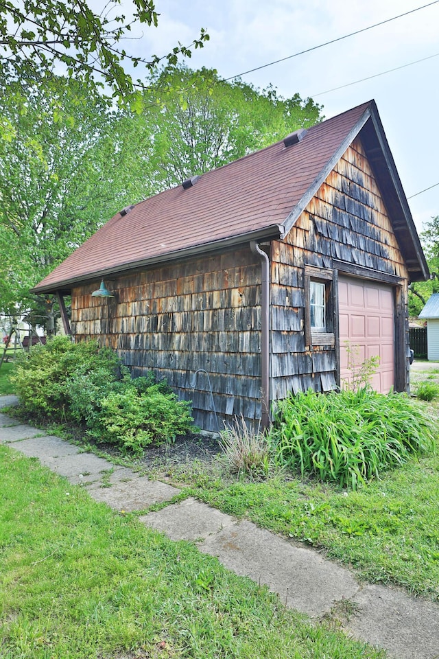 view of side of property with an outbuilding and a garage
