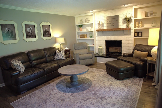 living room with ornamental molding, a textured ceiling, wood finished floors, and a fireplace