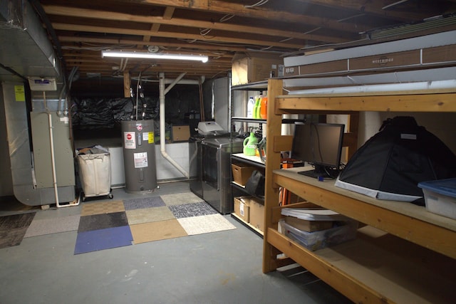unfinished below grade area featuring water heater, heating unit, and independent washer and dryer