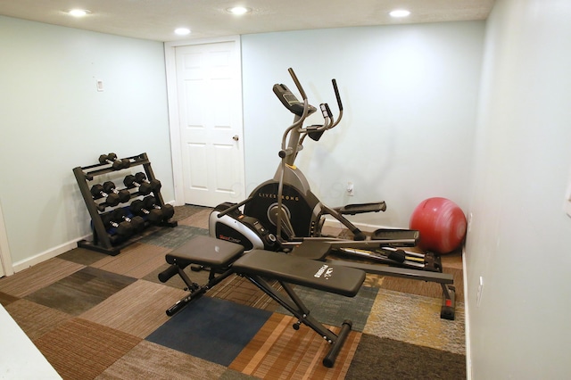 exercise area featuring baseboards and recessed lighting