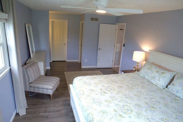 bedroom with visible vents, baseboards, ceiling fan, and wood finished floors