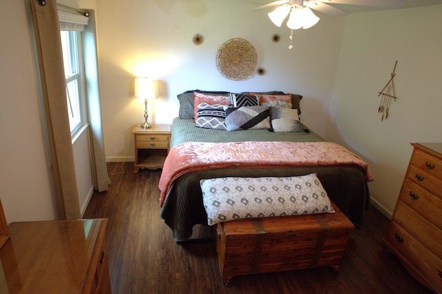 bedroom featuring baseboards and wood finished floors