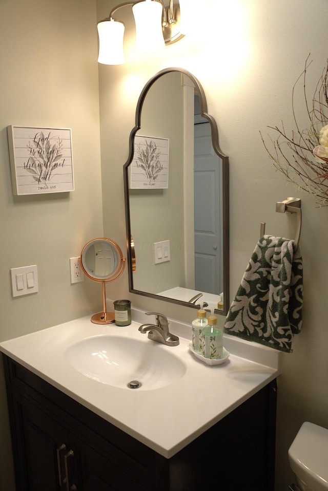 bathroom with toilet and vanity
