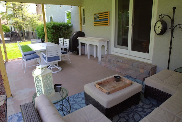 view of patio with fence and outdoor dining space