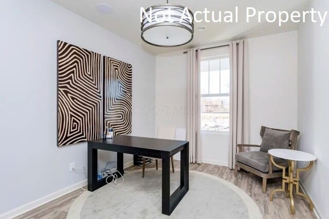 office area with baseboards and wood finished floors