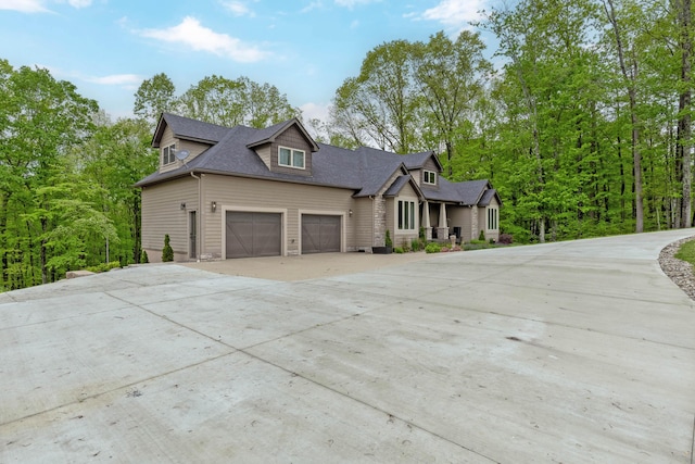 39403 State Route 689, Albany, OH 45710 - view of front facade featuring concrete driveway, roof with shingles, and an attached garage