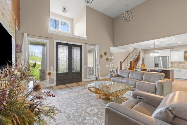 39403 State Route 689, Albany, OH 45710 - living area featuring a high ceiling, stairs, french doors, baseboards, and a chandelier