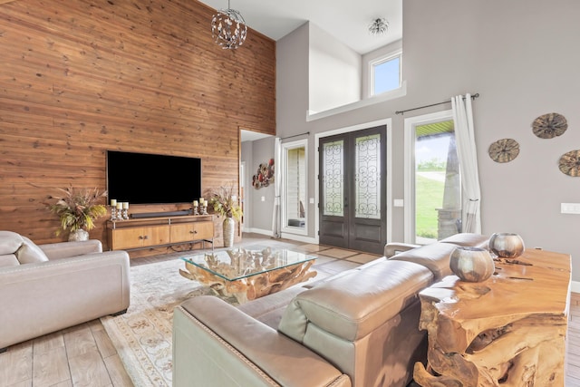 39403 State Route 689, Albany, OH 45710 - living room featuring a towering ceiling, wood walls, french doors, and wood finished floors