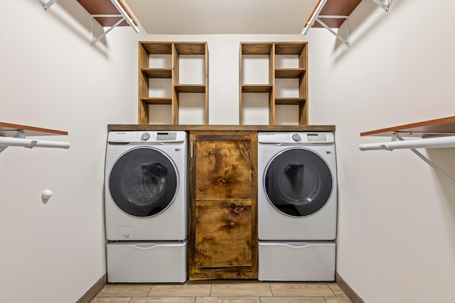 39403 State Route 689, Albany, OH 45710 - laundry area featuring washing machine and clothes dryer, baseboards, and wood finish floors