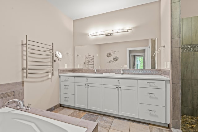 39403 State Route 689, Albany, OH 45710 - full bath with radiator heating unit, a garden tub, double vanity, a towel warmer, and tiled shower