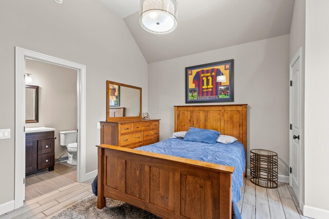 39403 State Route 689, Albany, OH 45710 - bedroom with vaulted ceiling, wood tiled floors, ensuite bathroom, and baseboards