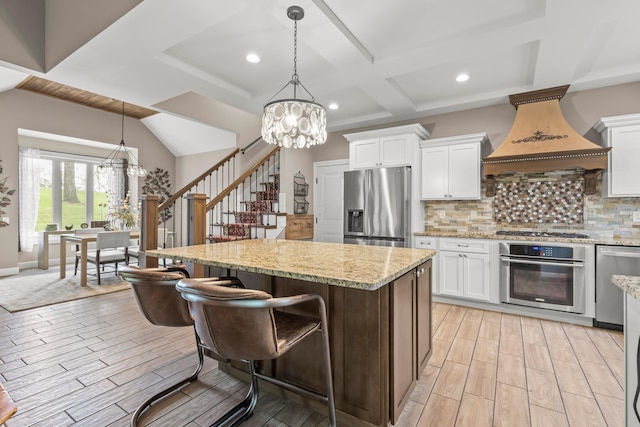39403 State Route 689, Albany, OH 45710 - kitchen with appliances with stainless steel finishes, a chandelier, a kitchen island, light wood-type flooring, and recessed lighting