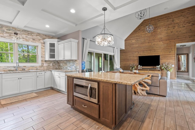 39403 State Route 689, Albany, OH 45710 - kitchen featuring stainless steel microwave, a sink, a chandelier, healthy amount of natural light, and a towering ceiling