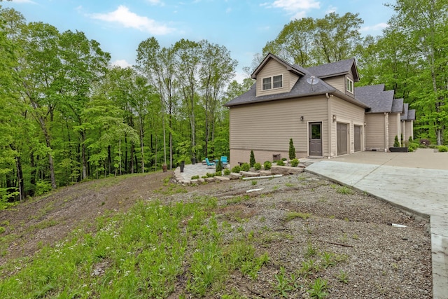 39403 State Route 689, Albany, OH 45710 - view of property exterior with driveway, a shingled roof, and an attached garage