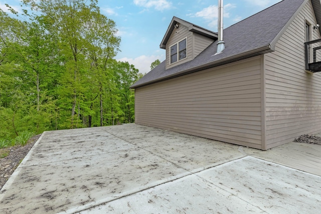 39403 State Route 689, Albany, OH 45710 - view of side of home featuring a patio and roof with shingles
