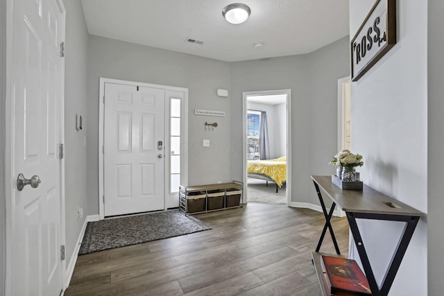 149 Broadmoore Blvd, Pataskala, OH 43062 - foyer entrance with visible vents, baseboards, and wood finished floors