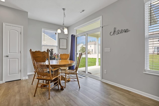 149 Broadmoore Blvd, Pataskala, OH 43062 - dining room featuring baseboards, wood finished floors, and visible vents