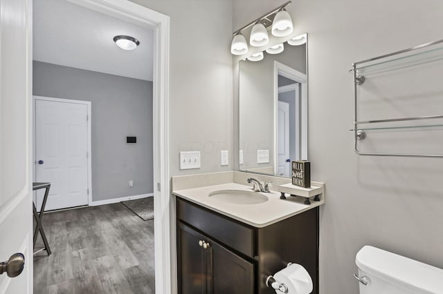149 Broadmoore Blvd, Pataskala, OH 43062 - half bath with toilet, baseboards, wood finished floors, and vanity