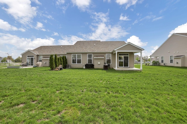 149 Broadmoore Blvd, Pataskala, OH 43062 - back of house featuring a lawn, a shingled roof, and a patio area