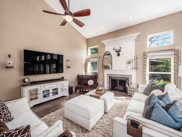 living area featuring ceiling fan, high vaulted ceiling, recessed lighting, wood finished floors, and a high end fireplace