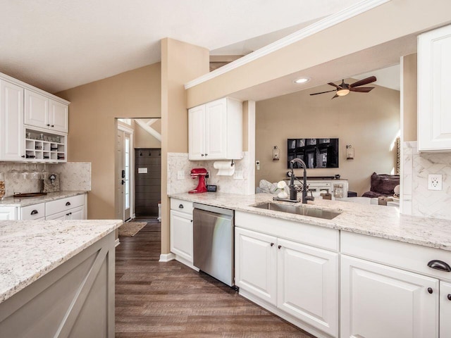kitchen with a sink, stainless steel dishwasher, vaulted ceiling, and backsplash