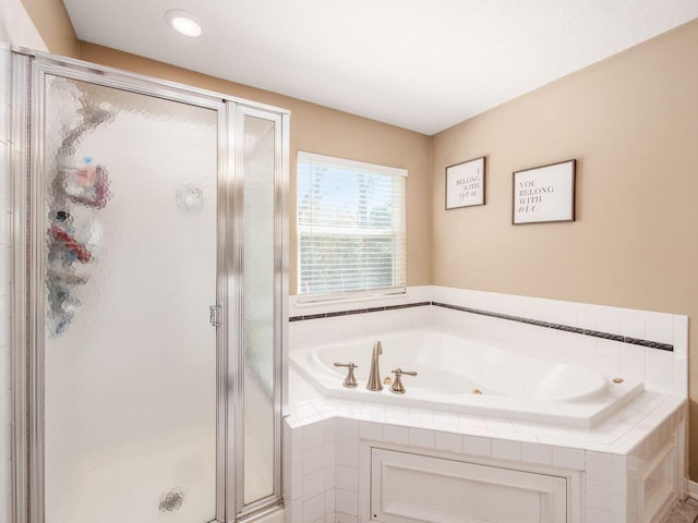 full bath featuring a garden tub and a shower stall