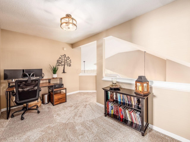 carpeted home office with baseboards
