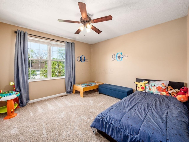 bedroom featuring carpet floors, a ceiling fan, baseboards, and visible vents
