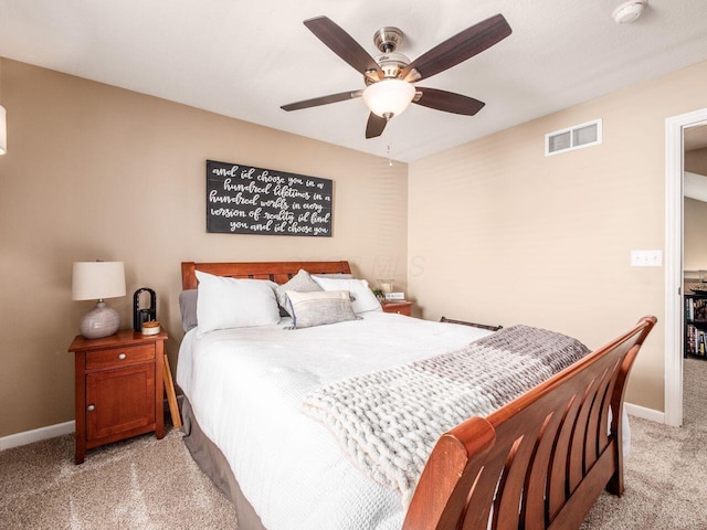 bedroom featuring visible vents, baseboards, ceiling fan, and light colored carpet