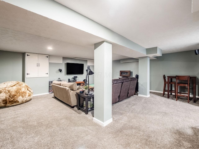 carpeted living room with baseboards