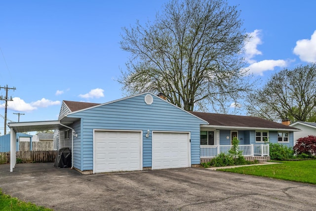 ranch-style home with a porch, a carport, fence, aphalt driveway, and an attached garage