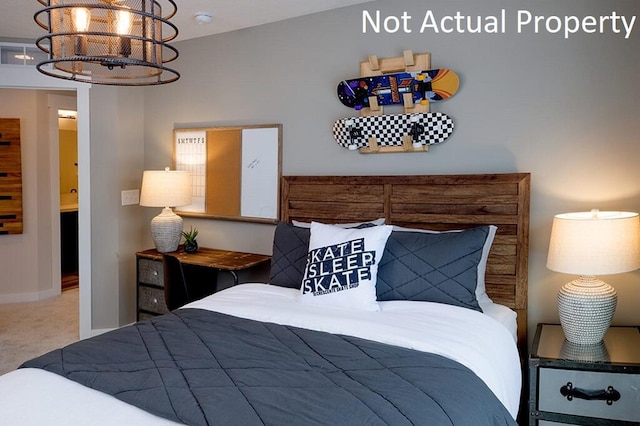 bedroom with baseboards, carpet, and a chandelier