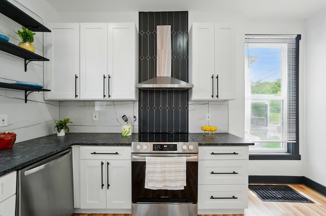 kitchen featuring open shelves, wall chimney exhaust hood, white cabinetry, and stainless steel appliances