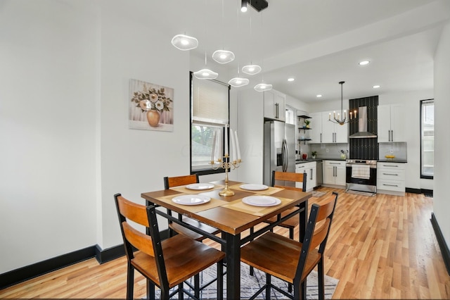 dining room with recessed lighting, light wood-style flooring, baseboards, and a notable chandelier