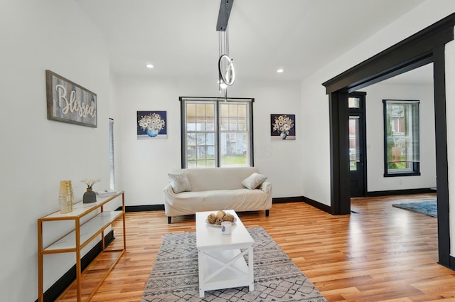 living room featuring light wood-type flooring, recessed lighting, and baseboards
