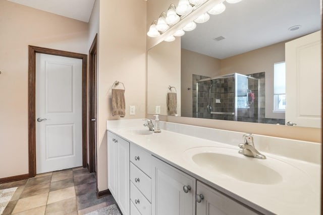 bathroom featuring visible vents, a sink, a stall shower, and double vanity