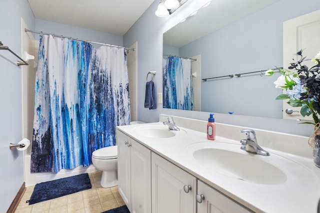 bathroom with a sink, tile patterned flooring, toilet, and double vanity