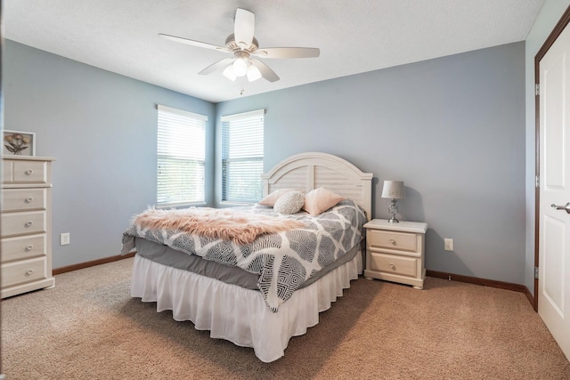 bedroom featuring baseboards, ceiling fan, and light carpet