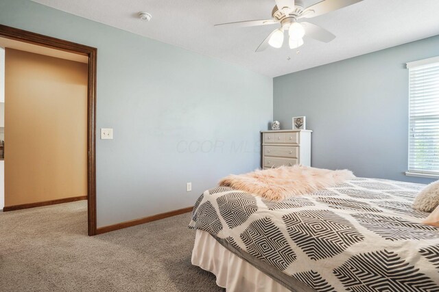 bedroom featuring baseboards, carpet flooring, and a ceiling fan