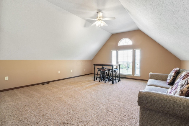 interior space with baseboards, light carpet, and lofted ceiling