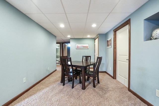 dining room with light colored carpet, recessed lighting, baseboards, and a drop ceiling