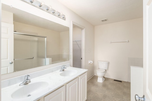 full bath featuring toilet, visible vents, a sink, and tile patterned flooring