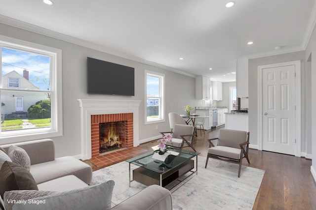 living area with crown molding, recessed lighting, a fireplace, and dark wood-type flooring