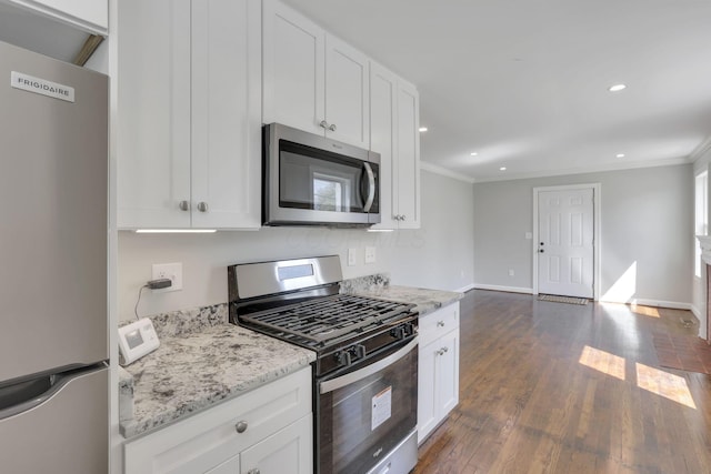 kitchen featuring crown molding, appliances with stainless steel finishes, white cabinets, and dark wood finished floors