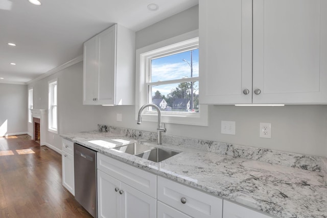 kitchen featuring white cabinets, a sink, and dishwasher
