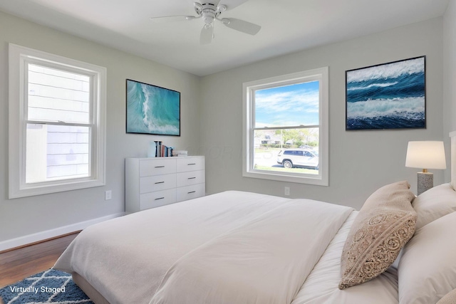 bedroom with baseboards, ceiling fan, and dark wood-style floors
